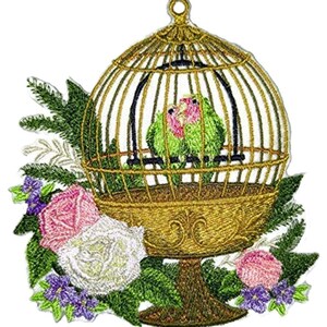 May include: An embroidered patch featuring a gold birdcage containing two green lovebirds with pink faces. The cage sits atop a pedestal surrounded by green fern leaves, a large white rose, a pink rose, and small purple flowers at the base.