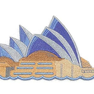 May include: Embroidered patch of the Sydney Opera House, featuring a beige building with blue and silver sails against a white background.