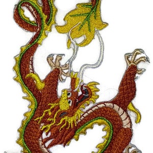 May include: An embroidered patch of a red and gold dragon with green and yellow accents. The dragon is curled up in a circle with its tail in its mouth.