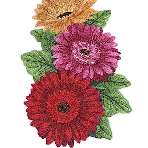 Puede incluir: Un ramo de tres margaritas gerbera bordadas en tonos naranja, rosa y rojo con hojas verdes.
