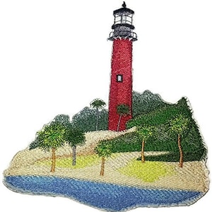 May include: Embroidered patch of a red lighthouse with a white trim and a black roof. The lighthouse is on a small island with green trees and a blue body of water.
