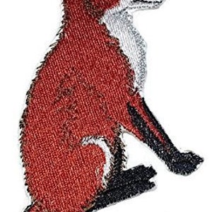 May include: An embroidered patch of a red fox sitting with its tail curled around its body. The fox has a white chest and a black nose.