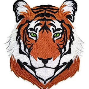 May include: Embroidered iron-on patch of a tiger's face with orange and white fur, black stripes, and green eyes.