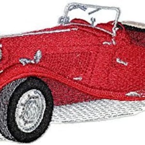 May include: A red vintage roadster with a white convertible top. The car has a chrome grill and headlights. The car is on a white background.