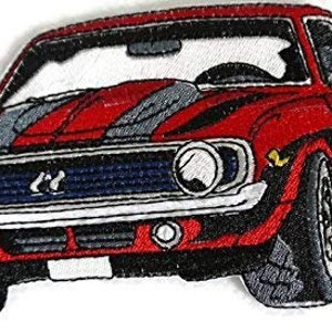 May include: Red embroidered patch of a classic muscle car with a black and gray stripe down the hood. The car has a black grille and white trim.
