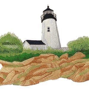 May include: Embroidered design of a white lighthouse with a black top, set against a backdrop of green foliage and brown rocky terrain. The lighthouse has a small window and is surrounded by a small white building with a black roof.