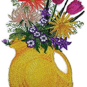 May include: Embroidered iron-on patch of a yellow pitcher filled with a bouquet of colorful flowers, including red, pink, white, and yellow flowers.