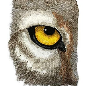 May include: Close-up of a brown and white animal's eye with a bright yellow iris. The eye is partially closed, giving a fierce and alert expression.