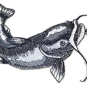 May include: Black and white embroidered patch of a catfish with its mouth open. The catfish is facing to the right and has a long whisker.