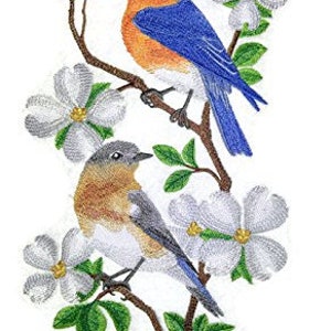 May include: Two embroidered bluebirds perched on a branch with white dogwood blossoms. The birds are detailed with blue, orange, and brown colors.