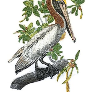 May include: Embroidered design of a brown and white pelican perched on a branch with green leaves. The pelican has a long yellow beak and is facing to the right.