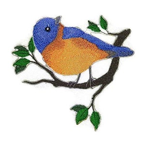 May include: Embroidered iron-on patch of a bluebird perched on a branch with green leaves. The bird has a blue head and back, orange breast, and black eyes.