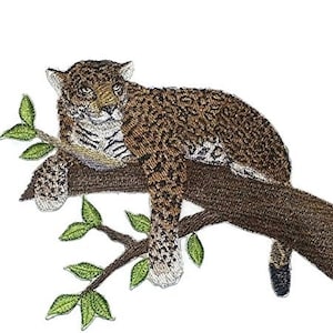 May include: Embroidered patch of a brown and black jaguar lying on a branch with green leaves.