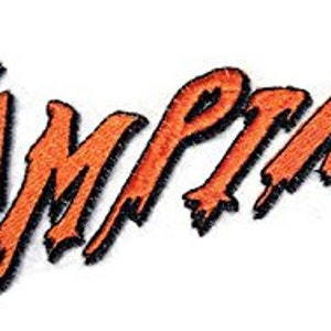 May include: Orange embroidered patch with the word "Vampires" in a dripping, stylised font.