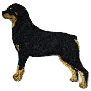 May include: Embroidered patch featuring a Rottweiler dog in a standing pose. The patch has a black body with tan markings on the legs, chest, and face. The dog is facing left, with detailed stitching.