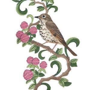 May include: Embroidered image of a bird perched on a branch with pink flowers and green leaves. The bird has brown and white feathers and a black beak. The branch is brown, and the background is white.