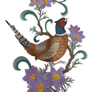 May include: Embroidered design of a pheasant perched among purple flowers and green foliage. The pheasant has brown, tan, and gray feathers, a red head, and a blue neck. The flowers have yellow centers.