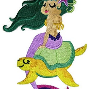 May include: An embroidered patch depicting a green-haired mermaid riding a yellow turtle. The mermaid has a purple tail and is wearing a purple and green dress. The turtle has a green shell and a yellow body.
