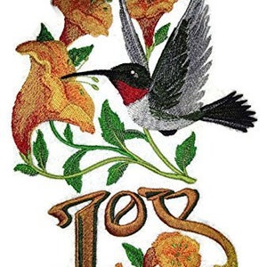 May include: Embroidered design featuring a hummingbird with outstretched wings, surrounded by yellow and orange flowers. The word "Joy" is embroidered in brown script below the hummingbird.