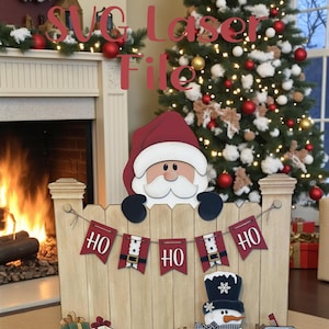 May include: A wooden Christmas-themed laser file design featuring Santa Claus, a snowman, and a sleigh. The design includes the text "SVG Laser File" and "Ho Ho" banners. A Christmas tree and fireplace are in the background.