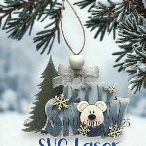 May include: A wooden Christmas ornament with the words "LET IT SNOW" and a polar bear design. The ornament has a silver bow, snowflakes, and a tree. The text "SVG Laser File" is at the bottom.