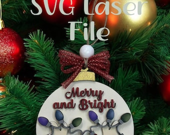 May include: A wooden Christmas ornament with the text "Merry and Bright" and a string of colorful lights. The ornament features a reindeer design and is topped with a red bow. The words "SVG Laser File" are also visible.