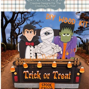 May include: A DIY wood kit for a Halloween truck featuring a vampire, mummy, and Frankenstein monster. The truck has a black bed with the words "Trick or Treat" and a sign that says "Spook Troop".
