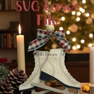 Op de afbeelding: Houten schaatsornament met een rood-groene geruite strik, een houten kraal en een zwart mes. De tekst "SVG Laser File" wordt in het rood weergegeven. Op de achtergrond een brandende kaars en een kerstboom.