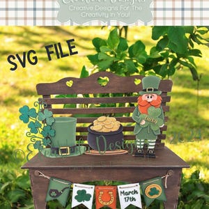 May include: A wooden bench with a leprechaun, a pot of gold, a shamrock, and a hat. The bench has a banner that says "March 17th".