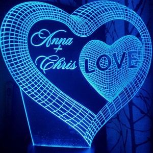 May include: A blue 3D printed heart-shaped night light with the words "Anna + Chris LOVE" inside.