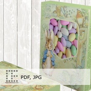 May include: A printable PDF and JPG file for a Peter Rabbit themed box with a window to hold candy. The box is decorated with a green background and a Peter Rabbit illustration. The window is filled with pastel-colored candy.