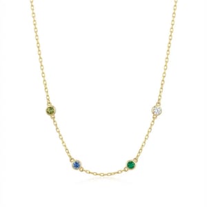 May include: A delicate gold necklace featuring a chain with four colorful gemstones: a light green, a blue, a green, and a clear stone. The necklace is a simple, elegant design, perfect for everyday wear.
