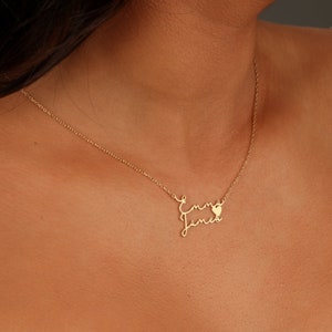 May include: Gold necklace with two names, "Emma" and "James", written in cursive script with a small heart symbol between the names.