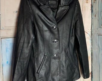 May include: A black leather jacket with a classic design. The jacket features a notched collar, three-button closure, and two front pockets. The label reads "Wilsons Leather".