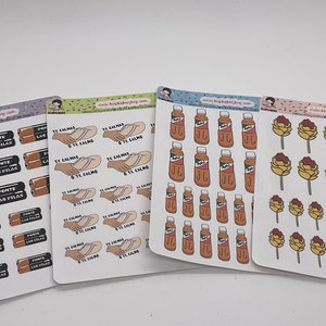 May include: Four sheets of stickers with various designs. The first sheet features a repeated design of a battery pack with the text "PONTE LAS PILAS". The second sheet features a repeated design of two hands holding a flip-flop with the text "TE CALMAS TE CALMO". The third sheet features a repeated design of a bottle of orange juice with a green label. The fourth sheet features a repeated design of a yellow and brown flower on a stick.
