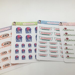 May include: A set of 10 sticker sheets featuring various fast food logos. The sheets are white with a colorful confetti border. The logos include A&W, Taco Bell, Krispy Kreme, and Applebee's.