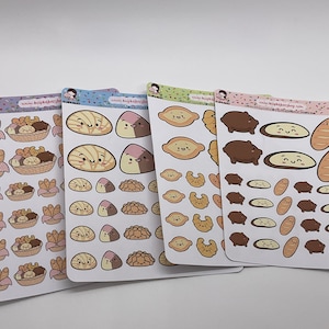 May include: Four sheets of stickers featuring various cute cartoon breads and pastries. The stickers are on a white background with confetti and the text "kawaii.bakery.etsy.com".
