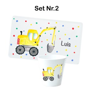May include: A yellow toy excavator with a gray bucket is on a white plate with colorful dots. The plate has the name "Luis" written on it. The set also includes a white cup with the same excavator design.