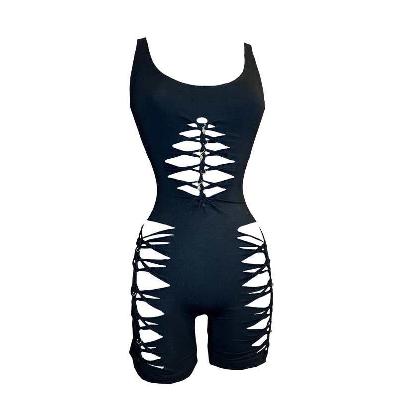 May include: Black sleeveless bodysuit with a lace-up design on the front and sides. The bodysuit has a scoop neck and a fitted silhouette.