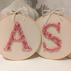 Embroidery frame with initials made of dried flowers