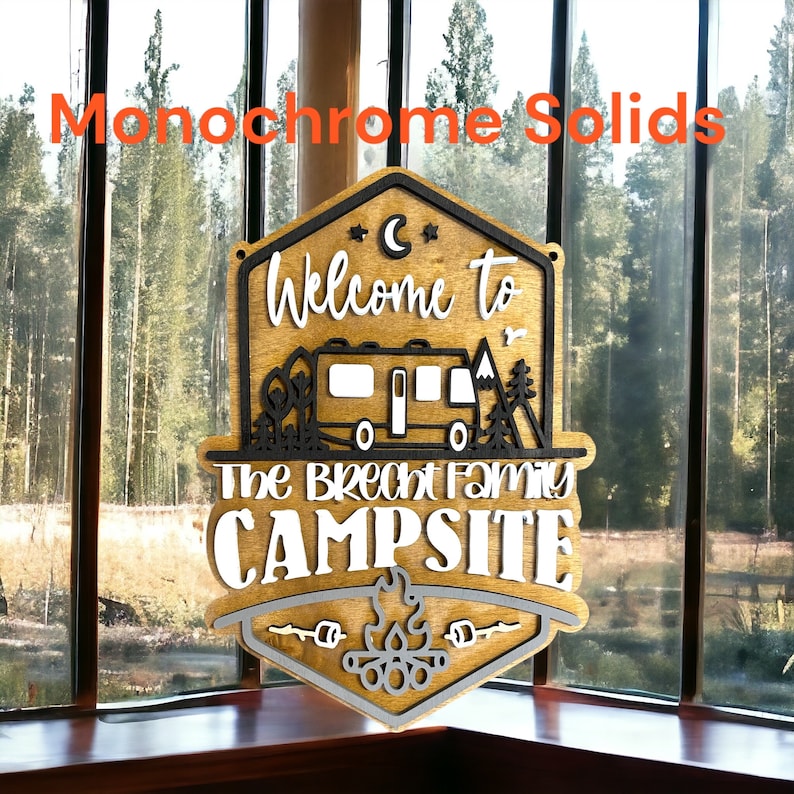 May include: A wooden sign with a welcome to the Brecht family campsite message. The sign is painted in brown, black, and white with a camper van, trees, and a campfire graphic.