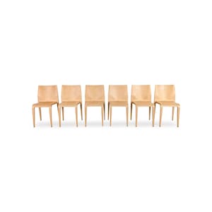 May include: A set of six light-toned wooden chairs, each featuring a curved backrest and a smooth, continuous seat design. The chairs are arranged in a straight line, showcasing a uniform grain pattern and a simple, four-legged structure.