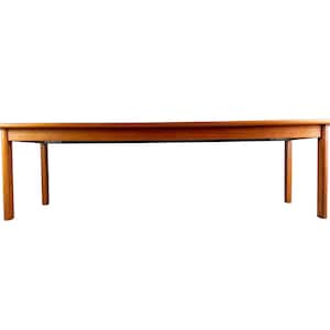 May include: A long, rectangular wooden coffee table with a warm, natural finish. The table has four straight legs and a simple, minimalist design. The table is approximately 60 inches long.