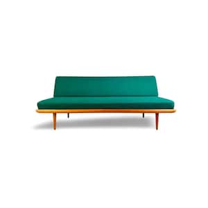 May include: A mid-century modern sofa with a teal green cushion and backrest. The sofa has a wooden frame and legs. The design is minimalist and features clean lines. The sofa is suitable for a living room or lounge area.