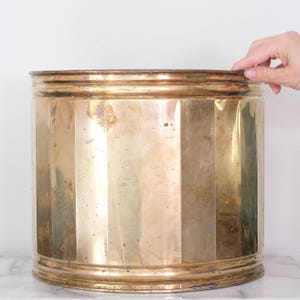 May include: A set of three ceramic mugs with a speckled, matte finish. The mugs are in shades of cream, light gray, and dark gray. Each mug has a simple, minimalist design and a rounded handle.