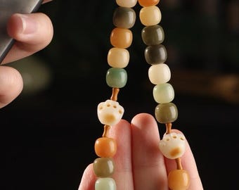 天然菩提樹「猫の足跡」携帯ストラップ ― スタイリッシュなアクセサリー