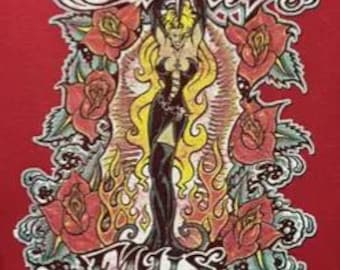 May include: Red t-shirt with a graphic featuring a woman with long blonde hair, a black dress, and a dagger, surrounded by roses and flames. The text "HELL" and "ELLS" is displayed in a stylized font.