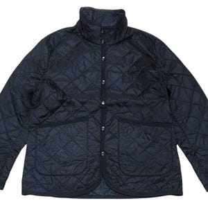 May include: A dark navy blue quilted jacket featuring a diamond-patterned stitch design, a high stand-up collar, long sleeves, and a front button closure with metallic snaps. The jacket includes two large patch pockets on the lower front section.