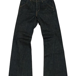 May include: Dark wash denim jeans with a flared leg design. The jeans feature a classic five-pocket style, a button and zip closure, and contrasting stitching. The jeans are a medium weight and appear unworn.