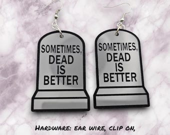 May include: A pair of silver-colored earrings shaped like tombstones with the text "Sometimes, Dead is Better" on each. The earrings are available in a variety of hardware options, including ear wire, clip on, lever back, kidney wire, or stud.